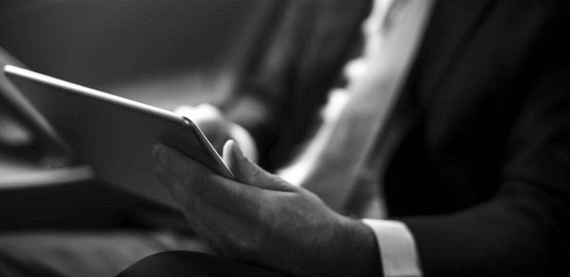 businessman using tablet working car inside