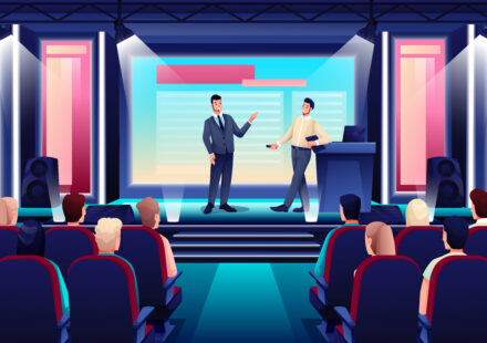 business conference or seminar in auditorium hall. speaker on podium giving presentation to audience in seats, event or forum convention in modern center.