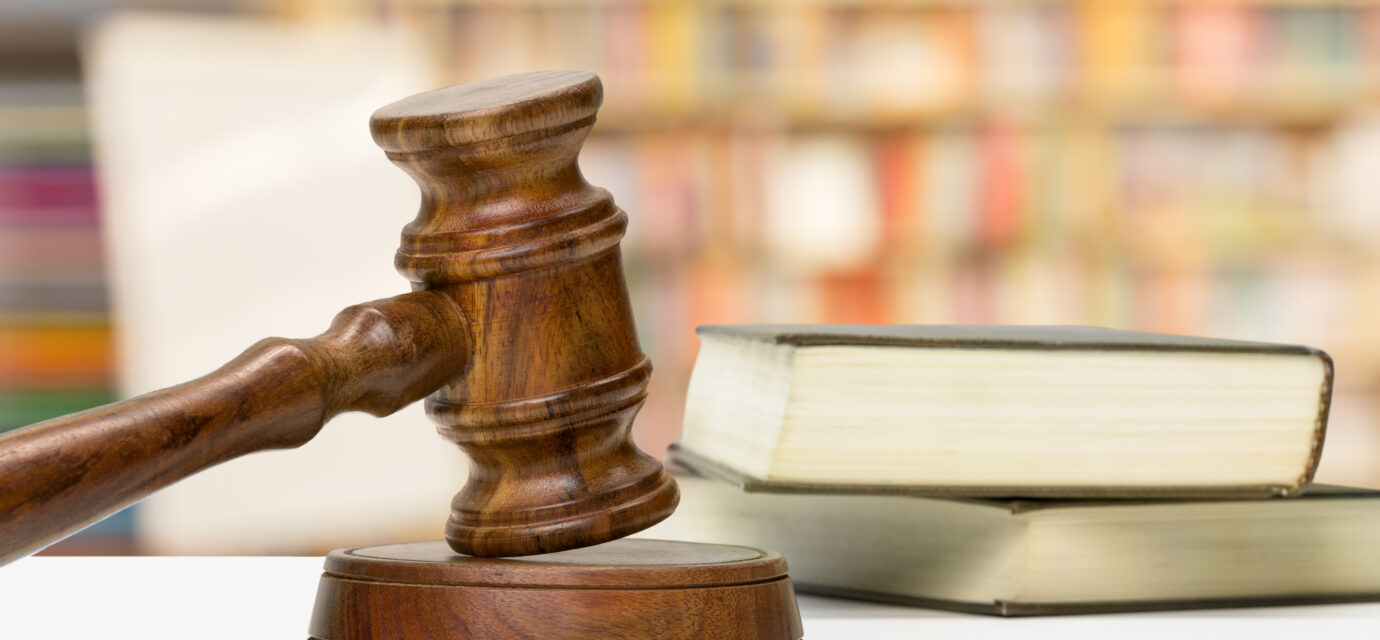 wooden gavel and books on wooden table