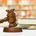 wooden gavel and books on wooden table