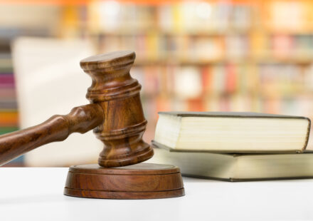 wooden gavel and books on wooden table